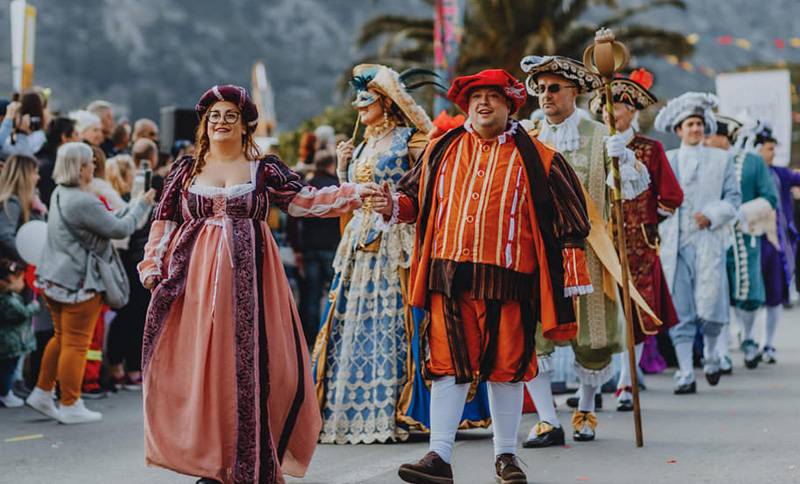 people dressed in costumes parade the streets of Kotor during the Kotor Carnival