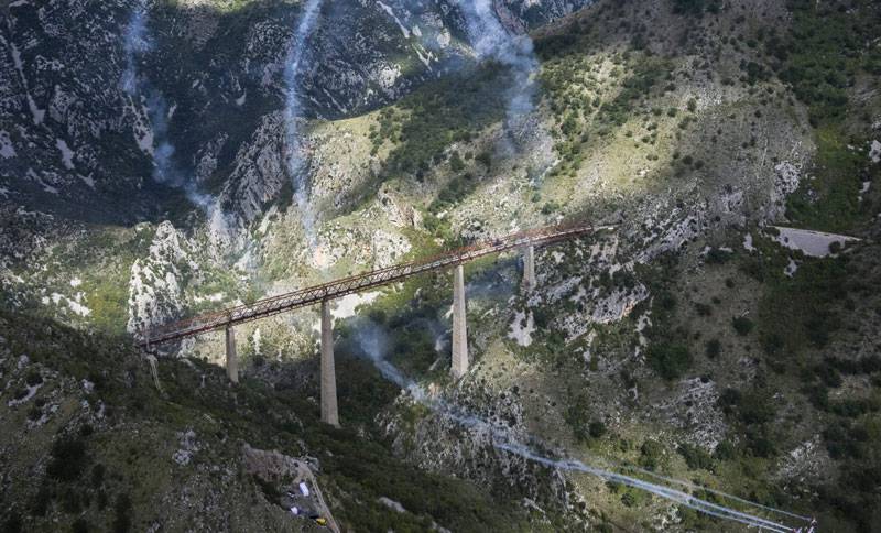 Red Bull pilots flying under the highest railway bridge in Europe in Mala Rijeka in Montenegro